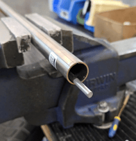 Debur cut end of tube